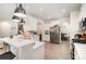 Well-lit kitchen featuring quartz countertops, stainless appliances, and a breakfast bar at 15636 Oleander Dr, Charlotte, NC 28278