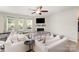 Bright living room featuring neutral tones, a fireplace, and ample seating at 15636 Oleander Dr, Charlotte, NC 28278