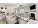 Open-concept living space featuring a comfortable seating area, fireplace, and plenty of natural light at 15636 Oleander Dr, Charlotte, NC 28278