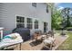 Outdoor patio area with grill, ample seating, and a basketball hoop in a fenced yard at 15636 Oleander Dr, Charlotte, NC 28278