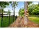 Scenic view of backyard leading to the lake, featuring a charming lakeside atmosphere and natural beauty at 16112 Terry Ln, Huntersville, NC 28078