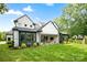 Expansive backyard featuring a lush lawn, new construction home, and outdoor seating at 16112 Terry Ln, Huntersville, NC 28078