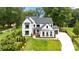 Beautifully landscaped property with a modern farmhouse and manicured lawn at 16112 Terry Ln, Huntersville, NC 28078