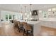 Modern kitchen features a large center island with seating, pendant lighting, and luxury appliances for a high-end culinary experience at 16112 Terry Ln, Huntersville, NC 28078