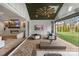 Stylish outdoor living space with brick flooring, a fireplace, and a retractable screen, ideal for year-round entertaining at 16112 Terry Ln, Huntersville, NC 28078