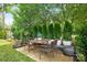 Charming outdoor patio setting with an outdoor dining area under mature trees at 16112 Terry Ln, Huntersville, NC 28078