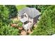 Aerial view of a well-maintained brick home with lush landscaping, a patio, and a picturesque backyard at 174 Hickory Hill Rd, Mooresville, NC 28117