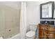Bathroom with a tub, toilet, and vanity with a dark granite countertop and decorative cabinet at 174 Hickory Hill Rd, Mooresville, NC 28117