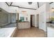 Bathroom featuring a soaking tub, glass shower, and vanity with decorative mirror and plenty of cabinet space at 174 Hickory Hill Rd, Mooresville, NC 28117