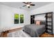 Bright bedroom features a ceiling fan, a large window, and a comfortable bed at 174 Hickory Hill Rd, Mooresville, NC 28117