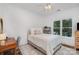 A well lit bedroom featuring hardwood floors, a desk area, and a comfortable bed at 174 Hickory Hill Rd, Mooresville, NC 28117