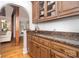 Butler's pantry featuring wooden cabinetry, granite countertop and hardwood flooring at 174 Hickory Hill Rd, Mooresville, NC 28117