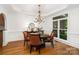 A formal dining room with hardwood floors, decorative chairs, and a chandelier at 174 Hickory Hill Rd, Mooresville, NC 28117