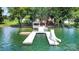 Aerial view of a dock with a slide, swim ladder, and gazebo, set against the backdrop of the lake at 174 Hickory Hill Rd, Mooresville, NC 28117