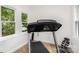 An exercise room with a treadmill, two windows providing great light, and workout accessories at 174 Hickory Hill Rd, Mooresville, NC 28117