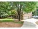 Charming home with a spacious driveway, lush lawn, mature trees, and serene lake views at 174 Hickory Hill Rd, Mooresville, NC 28117