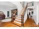 Elegant foyer with hardwood floors, curved staircase, and sophisticated architectural details at 174 Hickory Hill Rd, Mooresville, NC 28117