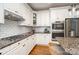 Well-equipped kitchen with granite countertops, stainless steel appliances, and white cabinets at 174 Hickory Hill Rd, Mooresville, NC 28117
