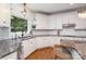 A kitchen featuring white cabinets, granite countertops, stainless appliances, and hardwood floors at 174 Hickory Hill Rd, Mooresville, NC 28117