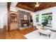 A living room with a fireplace, built-in shelving, and a view of the backyard at 174 Hickory Hill Rd, Mooresville, NC 28117