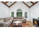 Comfortable living room with exposed wood beams, large windows, and a plush sectional sofa at 174 Hickory Hill Rd, Mooresville, NC 28117