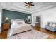 A light and bright main bedroom boasts a tray ceiling, elegant furnishings, and access to the ensuite at 174 Hickory Hill Rd, Mooresville, NC 28117