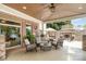 Spacious covered patio with brick columns, outdoor seating, and a view of the outdoor fireplace at 174 Hickory Hill Rd, Mooresville, NC 28117