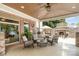 Spacious covered patio with brick columns, outdoor seating, and a view of the outdoor fireplace at 174 Hickory Hill Rd, Mooresville, NC 28117