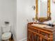 A powder room featuring an antique sink, gilded mirror, and toilet at 174 Hickory Hill Rd, Mooresville, NC 28117