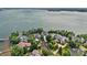 Aerial view of luxury waterfront homes and manicured lawns with a large body of water in the background at 18007 Harbor Light Blvd, Cornelius, NC 28031