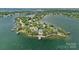 Stunning aerial view of waterfront homes nestled amongst trees and a large body of water at 18007 Harbor Light Blvd, Cornelius, NC 28031