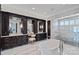 Elegant bathroom with dual vanities, a soaking tub, a glass walk-in shower and marble floors at 18007 Harbor Light Blvd, Cornelius, NC 28031