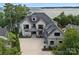 A beautiful, modern two story home with gray trim and a spacious, newly poured concrete driveway at 18007 Harbor Light Blvd, Cornelius, NC 28031