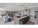 Open kitchen with granite island, stainless steel appliances, and adjacent living area at 18007 Harbor Light Blvd, Cornelius, NC 28031