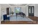 A living room features a grand piano, elegant blue decor, and coffered ceilings with a lake view at 18007 Harbor Light Blvd, Cornelius, NC 28031