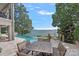 Lakeside infinity pool with stone patio and outdoor dining space at 18007 Harbor Light Blvd, Cornelius, NC 28031