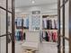 Spacious walk-in closet with custom shelving, an island with drawers, and carpeted floors at 18007 Harbor Light Blvd, Cornelius, NC 28031