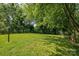 Expansive backyard featuring lush greenery, mature trees, and a serene outdoor setting at 1801 Teddington Dr, Charlotte, NC 28214