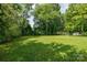 Large, sunny backyard featuring a well-manicured lawn, creating a peaceful outdoor space at 1801 Teddington Dr, Charlotte, NC 28214
