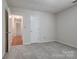 Cozy bedroom featuring neutral carpet, paint, and convenient hallway access at 1801 Teddington Dr, Charlotte, NC 28214