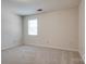 Bright bedroom with carpet, window, and neutral paint, creating a welcoming atmosphere at 1801 Teddington Dr, Charlotte, NC 28214