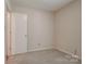 Neutral bedroom featuring plush carpeting, fresh paint, and a convenient closet at 1801 Teddington Dr, Charlotte, NC 28214