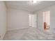 This bedroom offers comfortable carpet, neutral paint, and convenient access to the bathroom at 1801 Teddington Dr, Charlotte, NC 28214