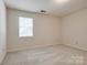 Bright bedroom featuring carpet, window, and neutral paint, providing a comfortable space at 1801 Teddington Dr, Charlotte, NC 28214