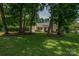 Charming home nestled among mature trees with lush green lawn and manicured landscaping at 1801 Teddington Dr, Charlotte, NC 28214