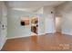 Open-concept living room with vaulted ceiling, hardwood flooring, and an adjacent kitchen view at 1801 Teddington Dr, Charlotte, NC 28214