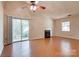 Bright living room featuring sliding glass doors to the backyard, hardwood floors, and a fireplace at 1801 Teddington Dr, Charlotte, NC 28214