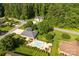 Scenic aerial view of a beautiful brick home with a swimming pool surrounded by lush trees at 1958 Cameron Heights Cir, Denver, NC 28037