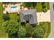 Aerial view of a home with lush landscaping, in-ground pool, and a well-maintained lawn at 1958 Cameron Heights Cir, Denver, NC 28037