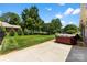 Backyard with a fenced yard, mature trees, and a red, above-ground hot tub ready for relaxation at 1958 Cameron Heights Cir, Denver, NC 28037